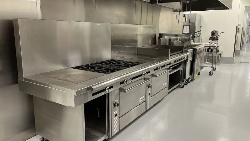 Commercial kitchen at Amazon Air with cooking line and stainless steel appliances