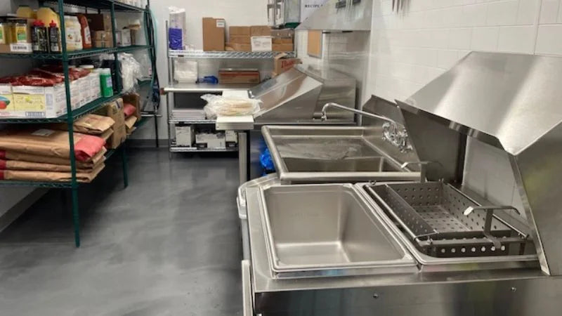 Dishwashing area with 3-compartment sink, chemical dispensers, and warewashing setup