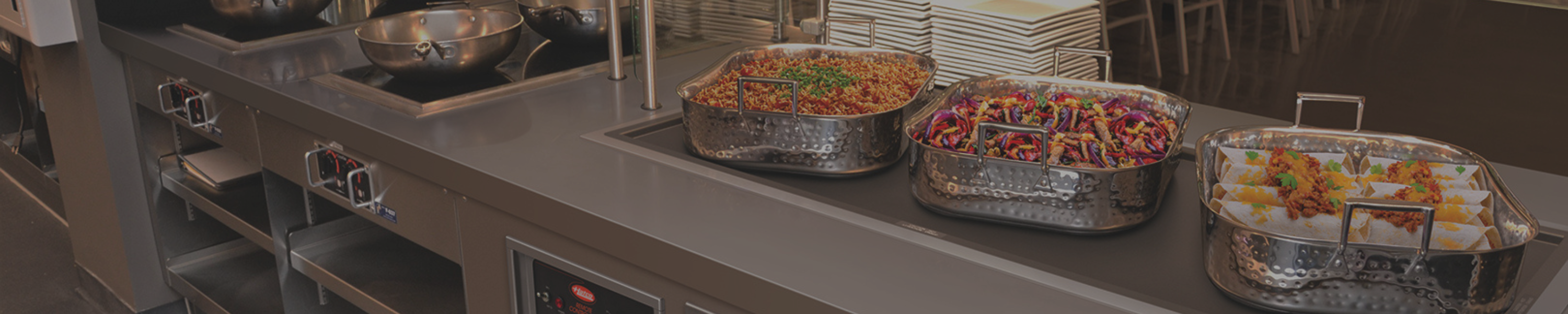 Hatco drop-in heated buffet station featuring stainless steel food pans filled with hot prepared dishes.