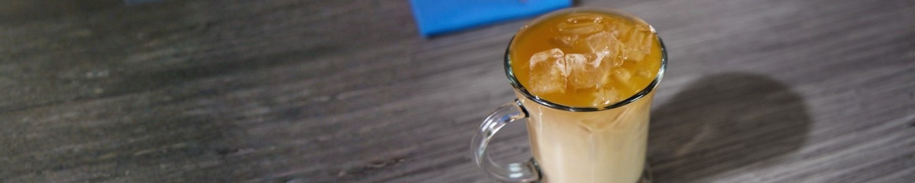 Iced coffee with ice cubes rising in a glass mug
