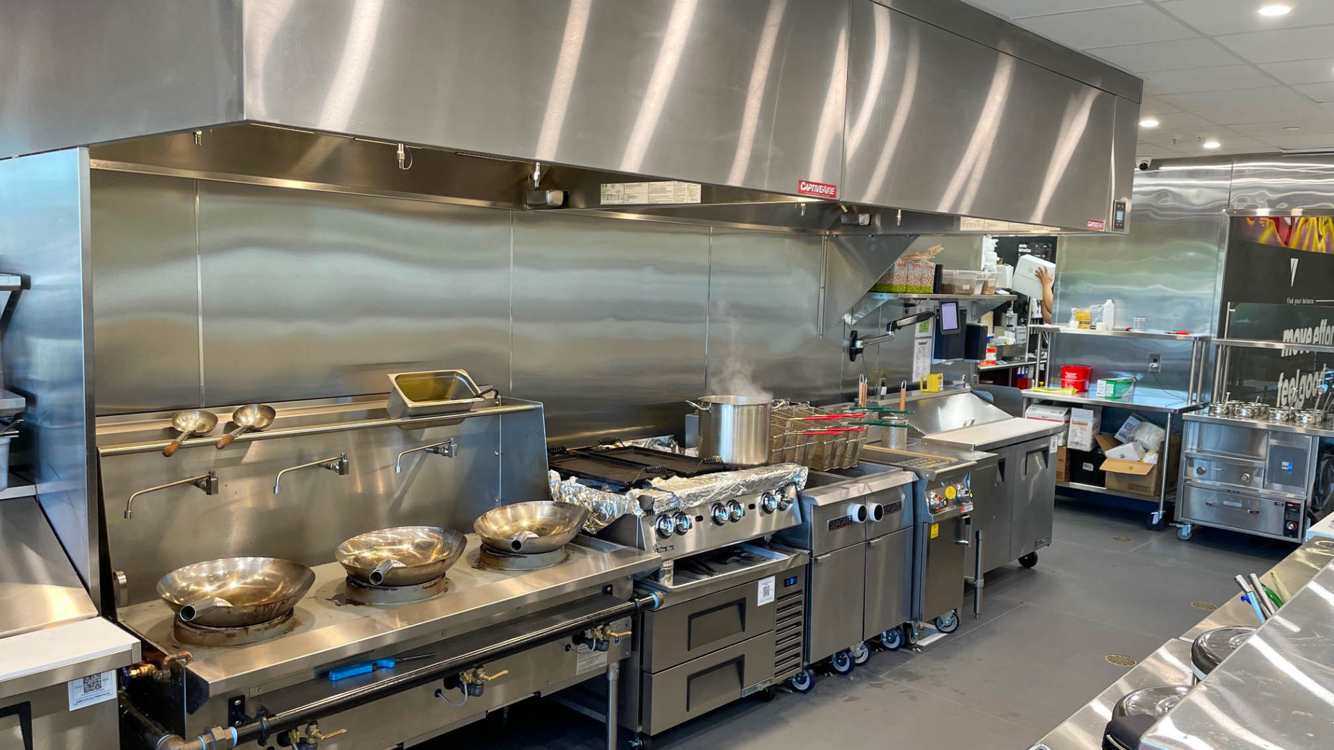Commercial kitchen with stainless steel appliances and equipment