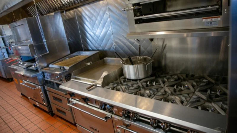 Commercial kitchen with stainless steel appliances and stovetop
