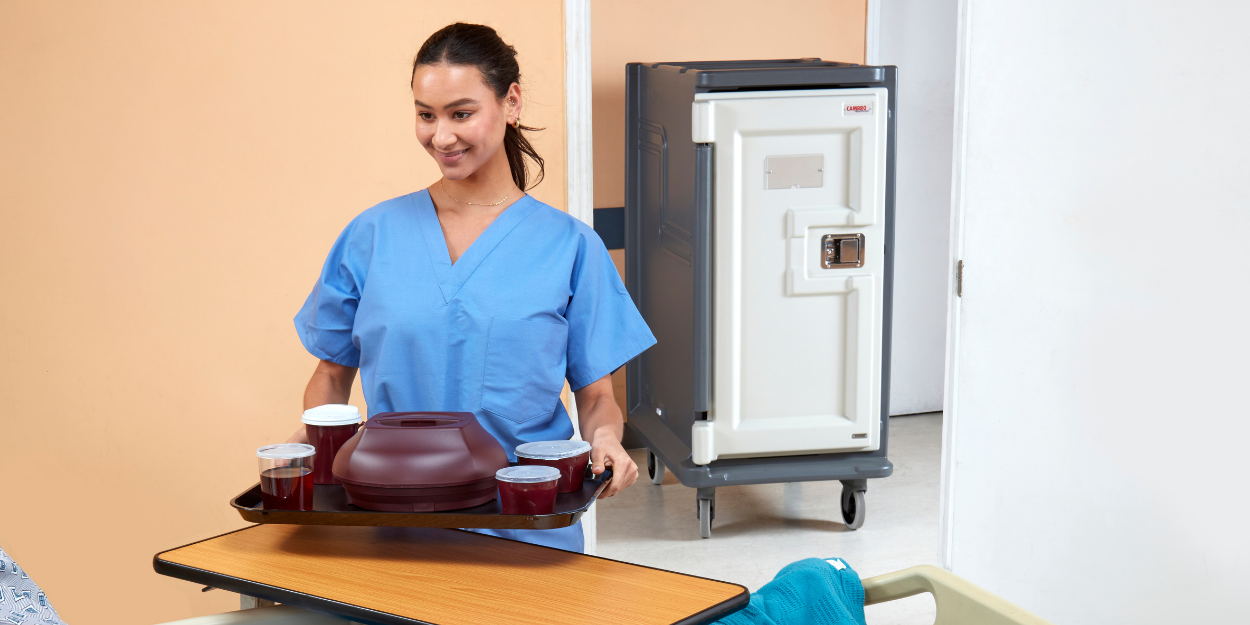 Professional healthcare meal delivery system featuring an insulated tray, covered meal service, and a mobile temperature-controlled transport cart for clinical food service.