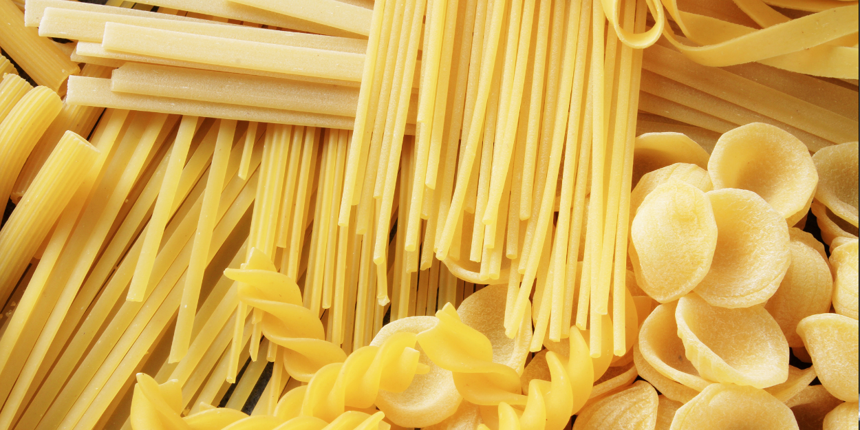 Fresh pasta on a drying tray, highlighting the precision and efficiency of commercial dough processing equipment.