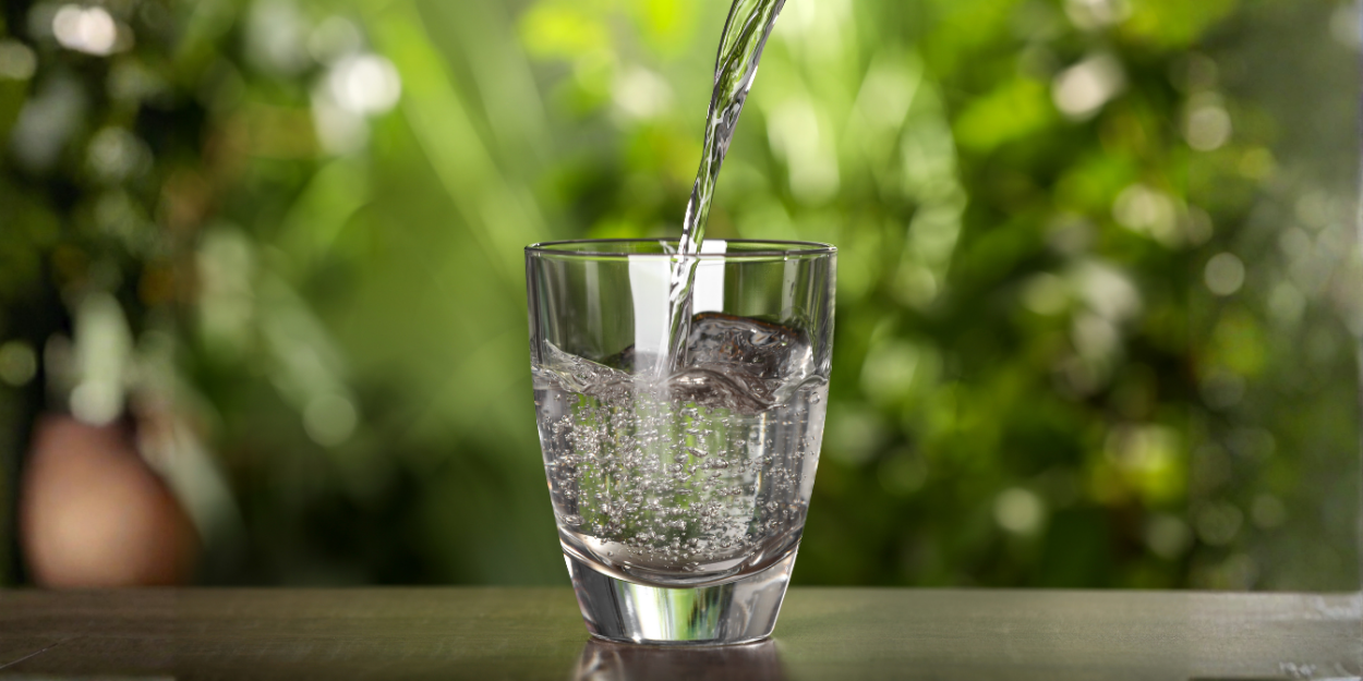Clean filtered drinking water pouring into glass