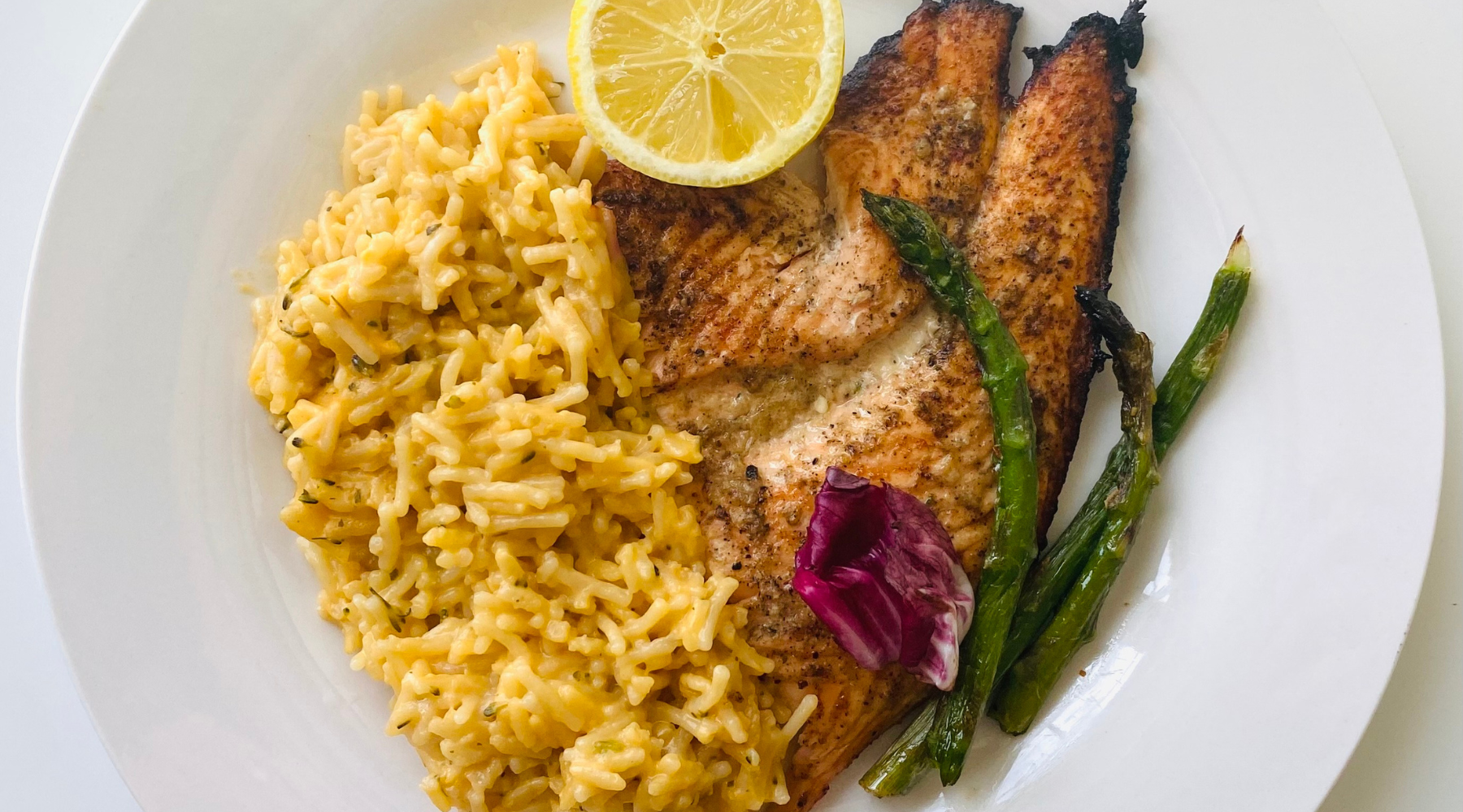 Close-up of steamed broccoli and cauliflower on a dark surface