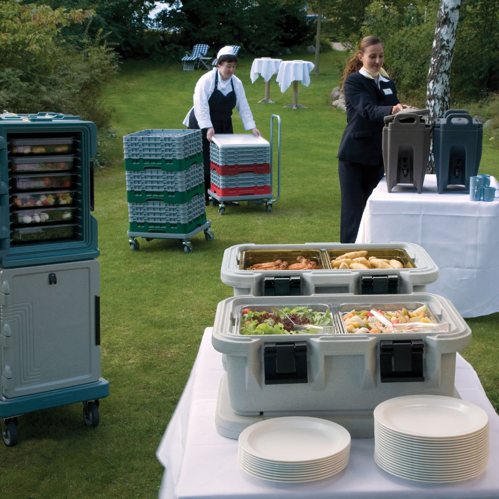 Outdoor catering setup with various Cambro insulated food & beverage carriers