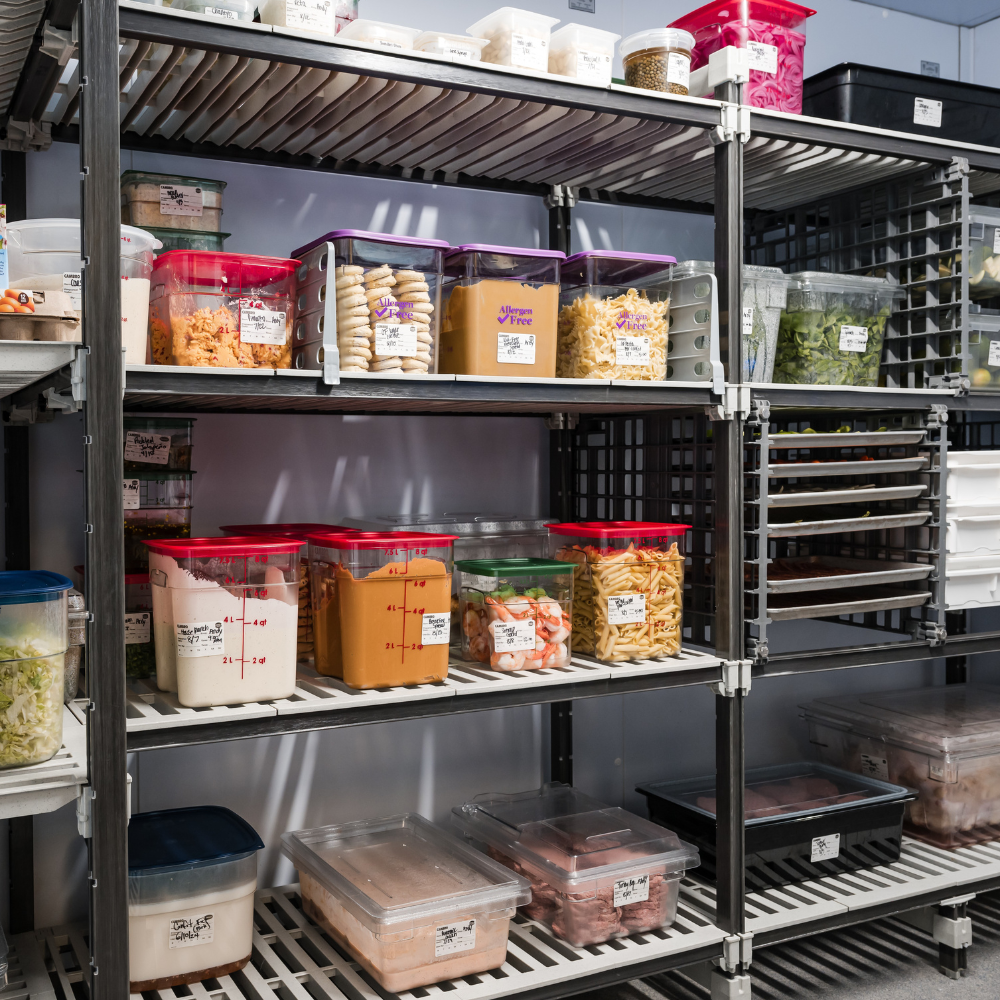 Shelving unit with various Cambro food containers and food pans in a storage area.