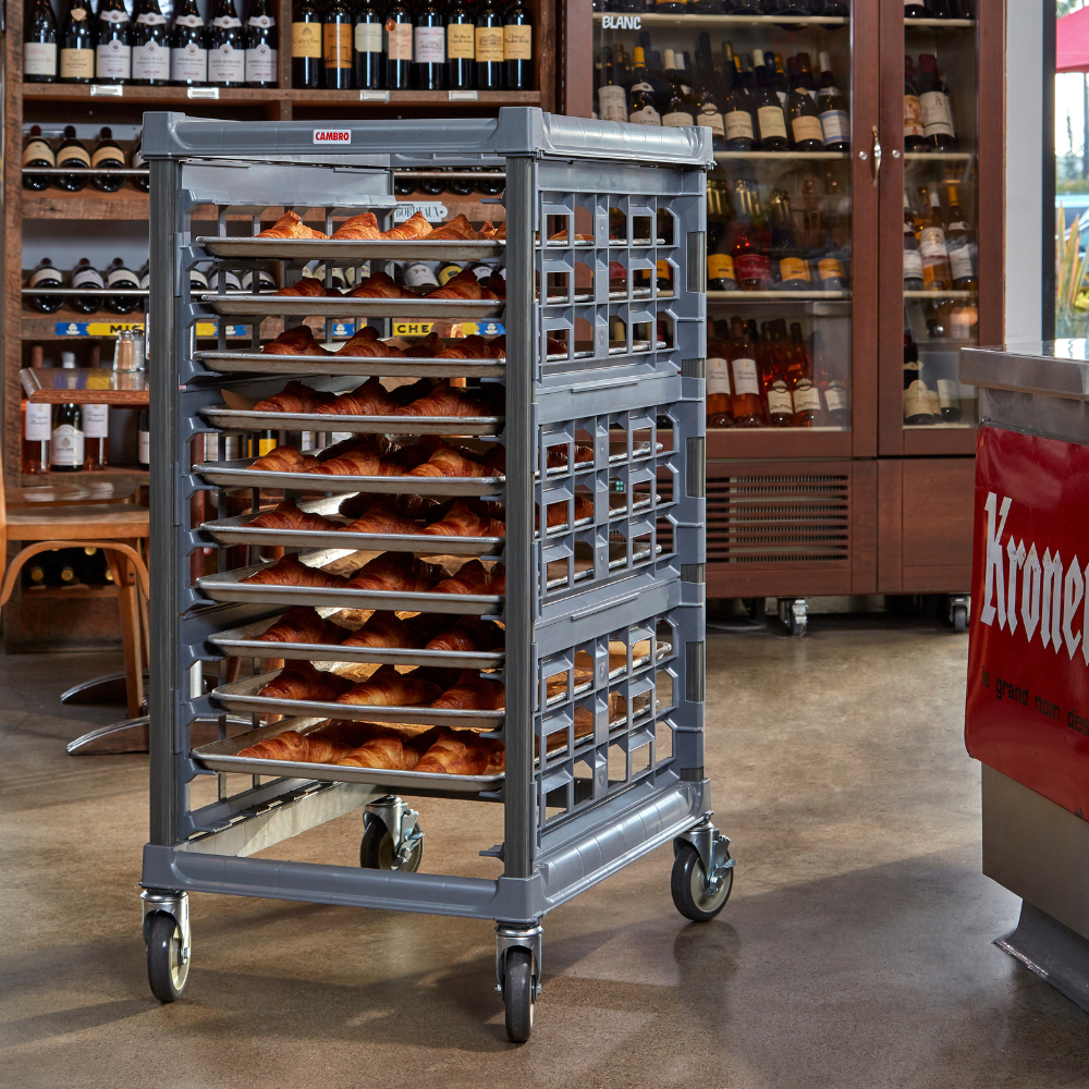 Gray Cambro pan rack filled with sheet pans of croissants in a store