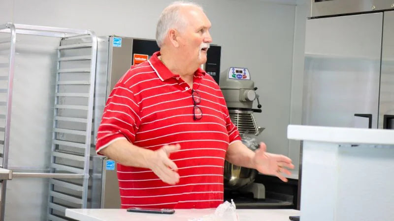 Cafe owner discussing coffee shop kitchen layout and equipment setup