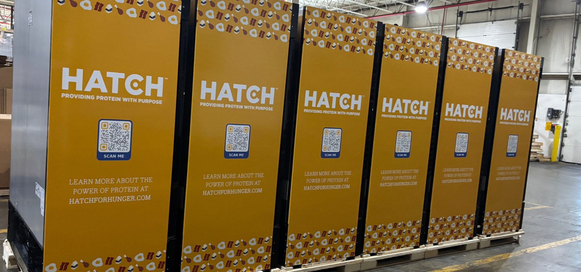 A line of custom-wrapped HATCH for Hunger commercial refrigerated merchandisers