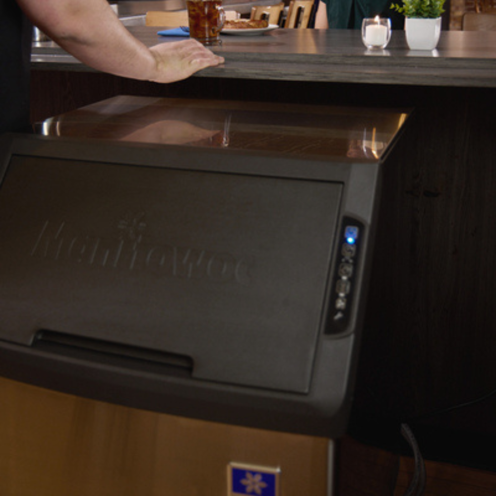 Manitowoc ice machine under a bar counter