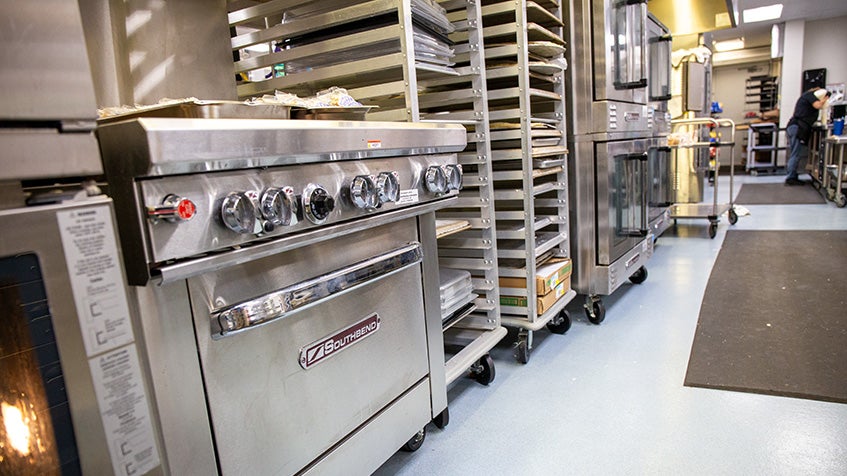 Commercial kitchen oven and bakery racks in professional foodservice kitchen