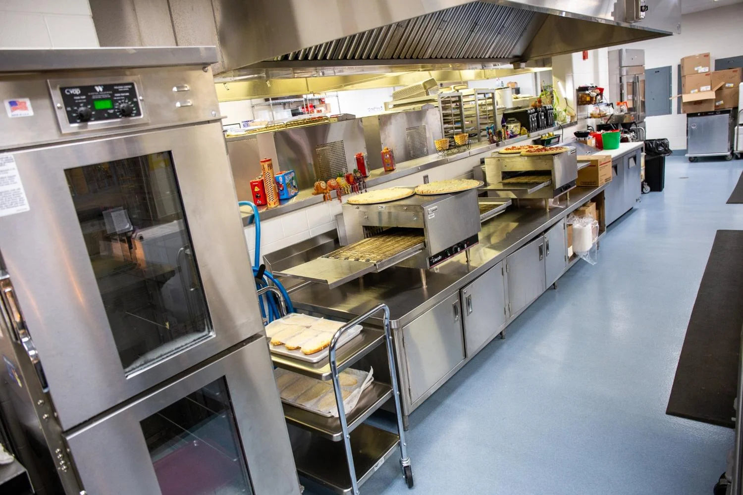 Northwood High School cafeteria kitchen. Cooking pizzas.