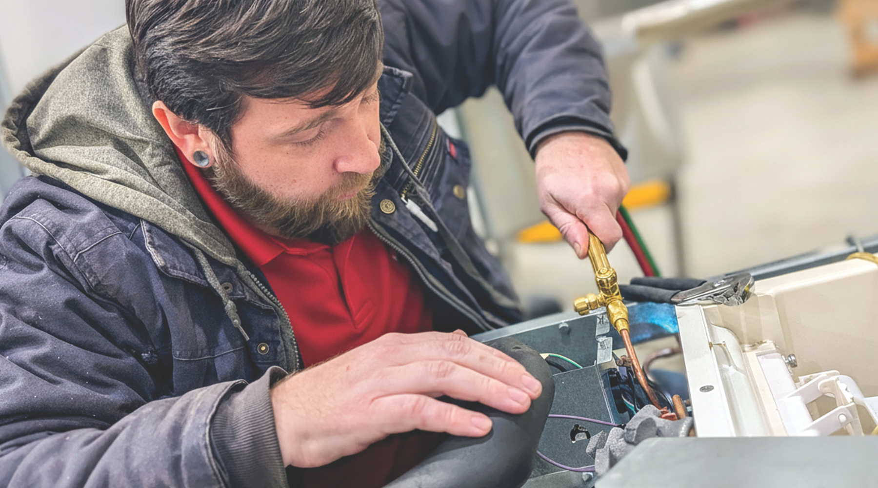 Service technician performing maintenance on a commercial ice maker.