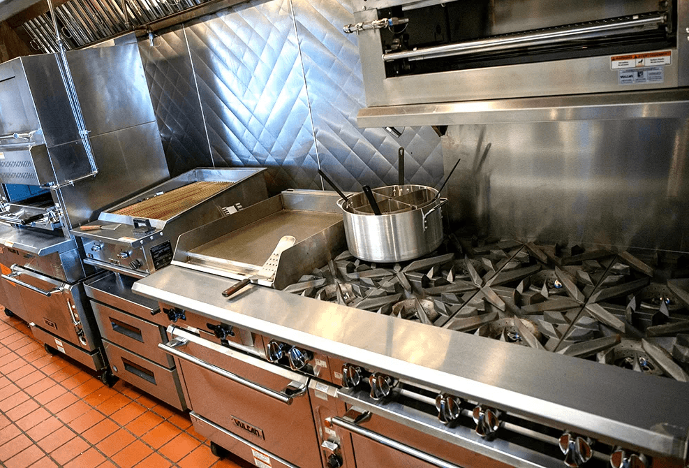 Commercial kitchen with stainless steel appliances and stovetop