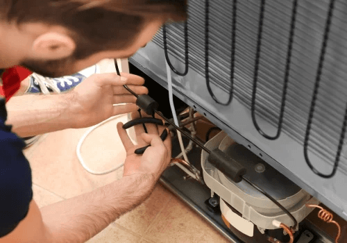 Person working on an air conditioning unit