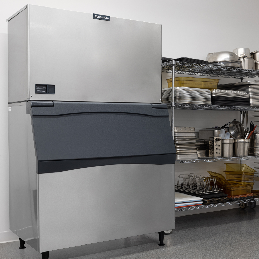 Large capacity Scotsman ice machine head on an ice bin in a commercial kitchen.