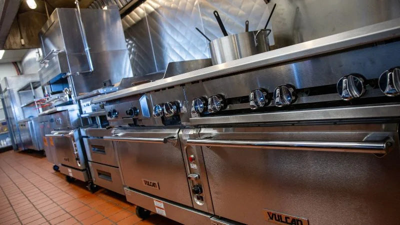 Stainless steel kitchen appliances with 'Vulcan' branding in a professional kitchen setting.