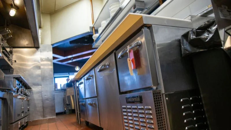 Commercial kitchen with stainless steel appliances and equipment.
